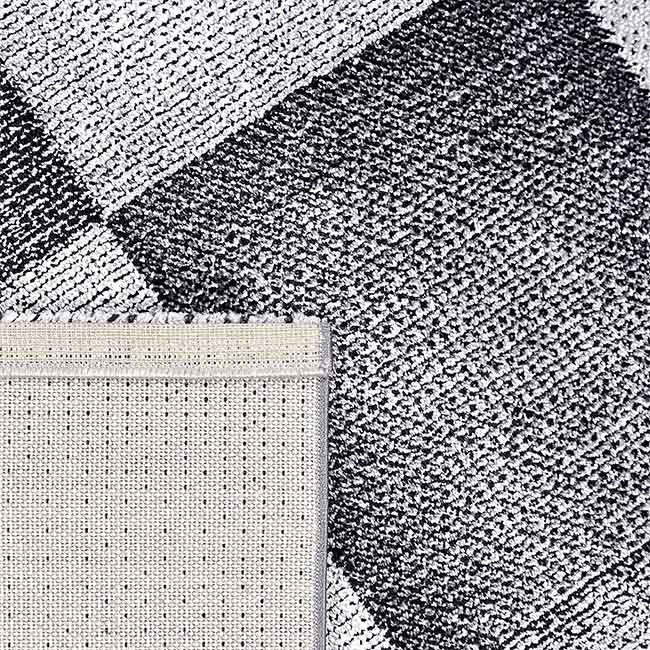 Achterkant hoek aanzicht van het vloerkleed DAKREN in de kleur Grijs, gemaakt van Polyester.