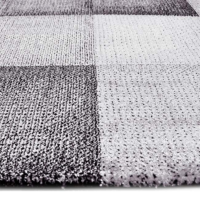 Zijkant detail aanzicht van het vloerkleed DAKREN in de kleur Grijs, gemaakt van Polyester.