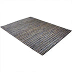 Diagonaal aanzicht van het vloerkleed DENVAR in de kleur Grijs, gemaakt van Jute.