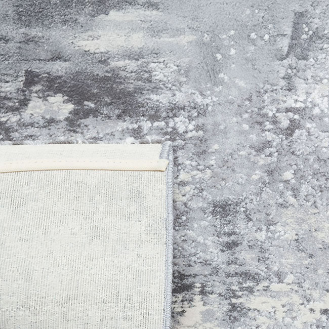 Achterkant hoek aanzicht van het vloerkleed DRAVEN in de kleuren Creme / Grijs, gemaakt van Polyester.