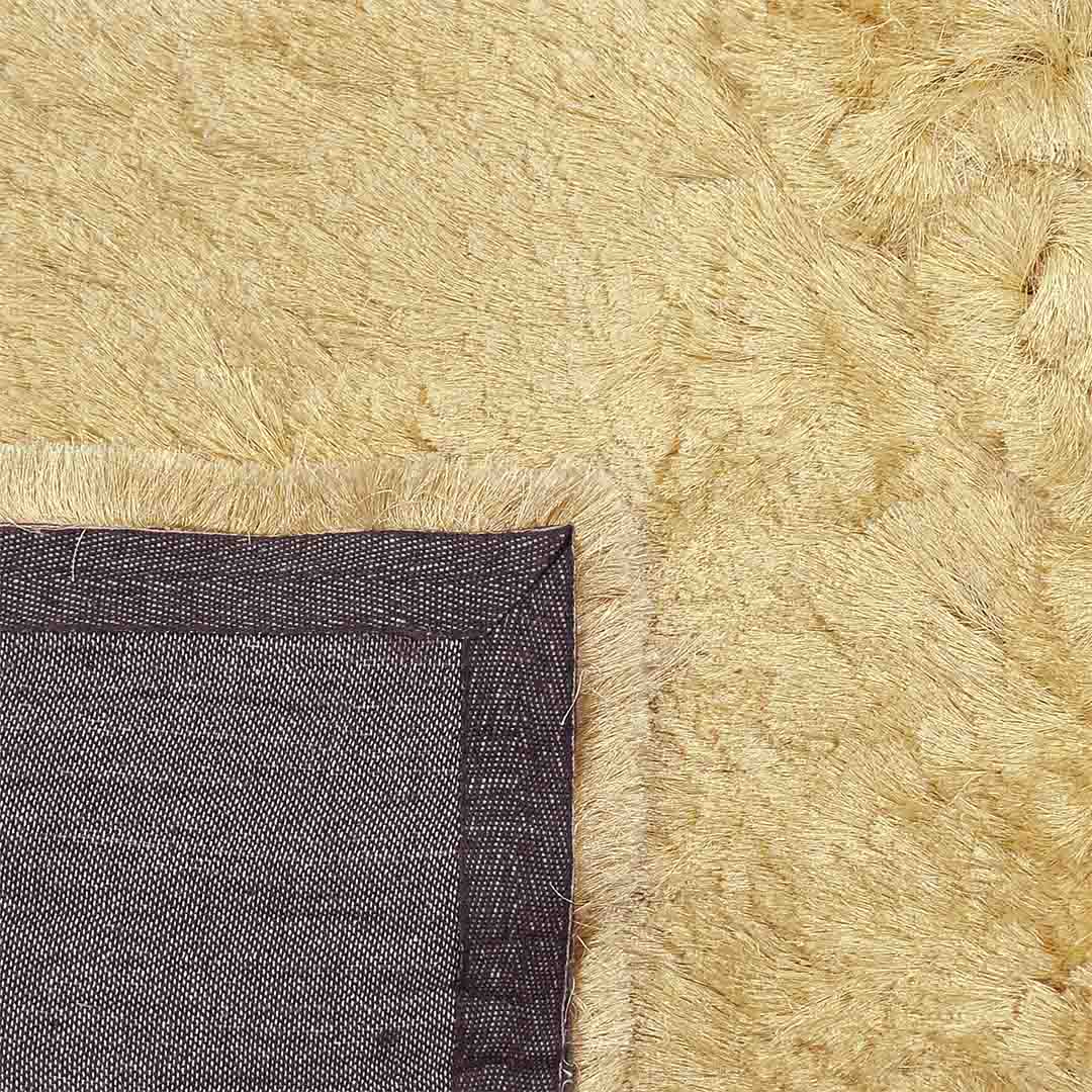 Achterkant hoek aanzicht van het vloerkleed INDIRA in de kleur Beige, gemaakt van Polyester.