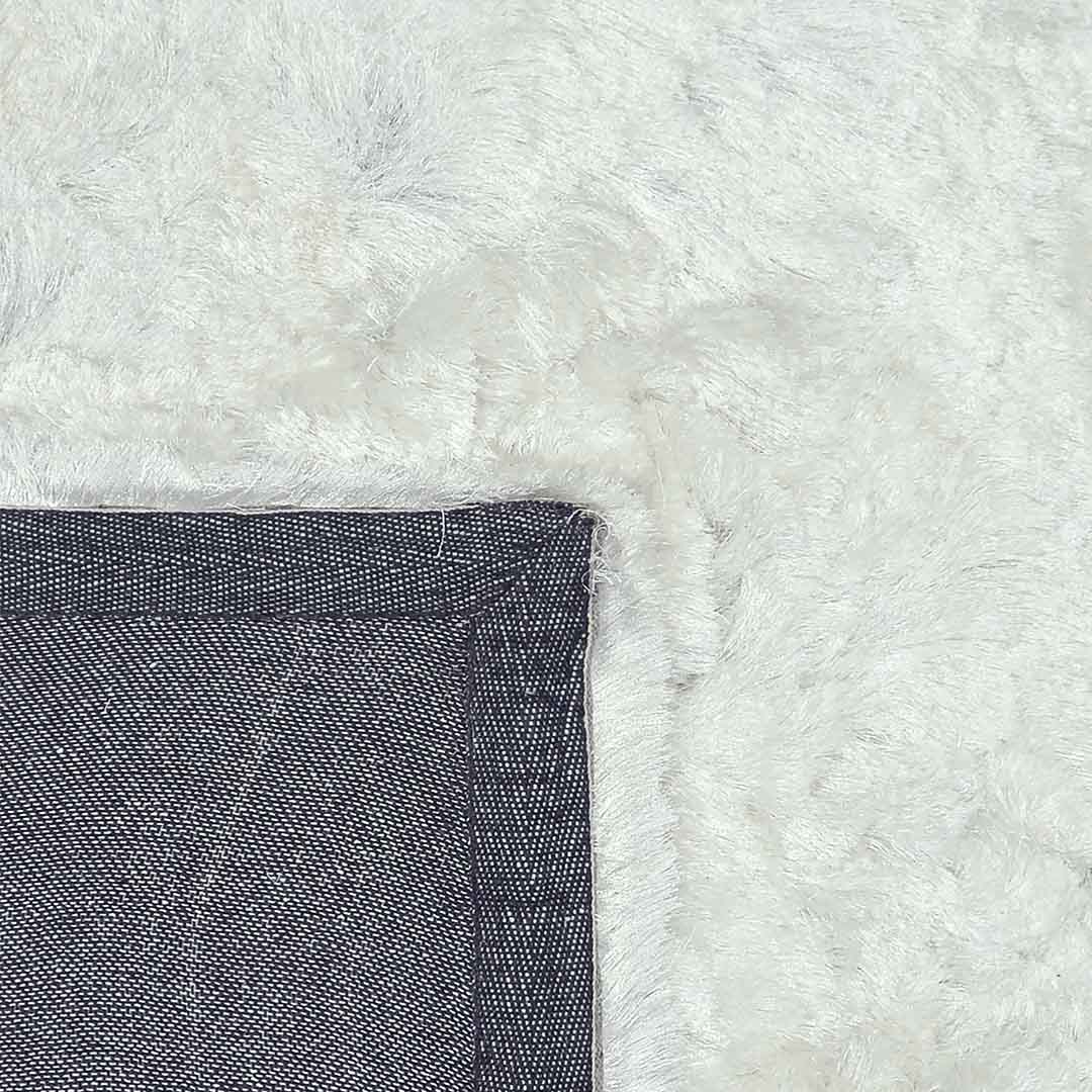 Achterkant hoek aanzicht van het vloerkleed INDIRA in de kleur Wit, gemaakt van Polyester.