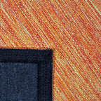 Achterkant hoek aanzicht van het vloerkleed LYDEN in de kleur Oranje, gemaakt van Katoen.