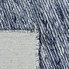 Achterkant hoek aanzicht van het vloerkleed MORDANA in de kleur Blauw, gemaakt van Wol en Polyester mix.