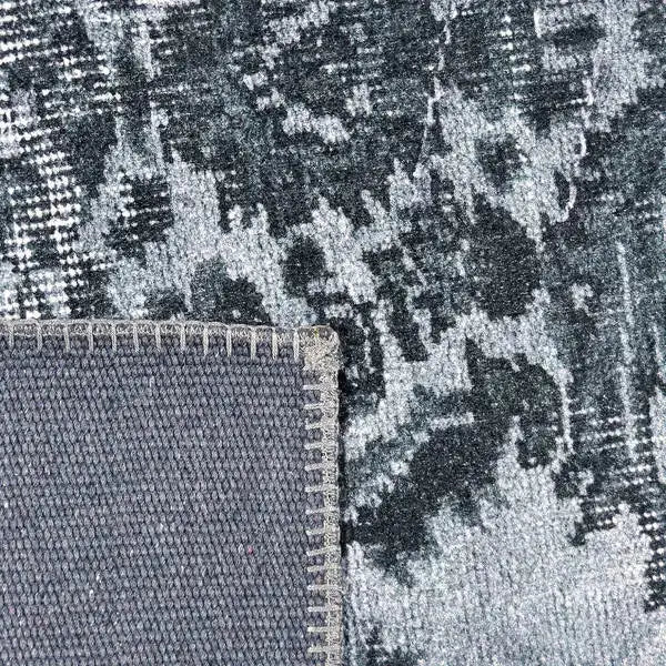 Achterkant hoek aanzicht van het vloerkleed NEXON in de kleur Grijs, gemaakt van Polyester.
