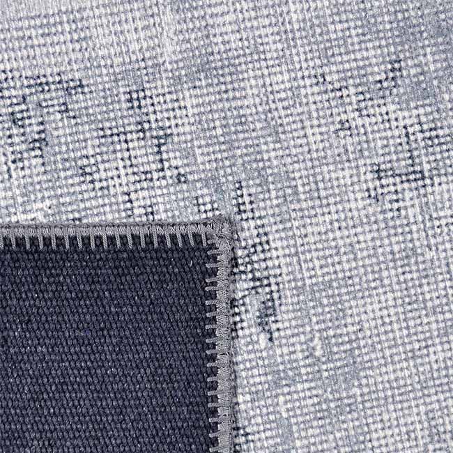 Achterkant hoek aanzicht van het vloerkleed NEXON patch in de kleur Grijs, gemaakt van Polyester.