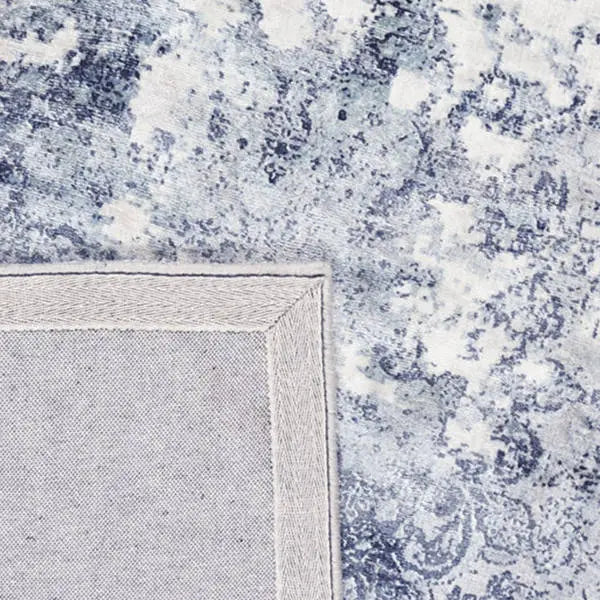 Achterkant hoek aanzicht van het vloerkleed VALCERA modern in de kleur Blauw, gemaakt van Viscose.